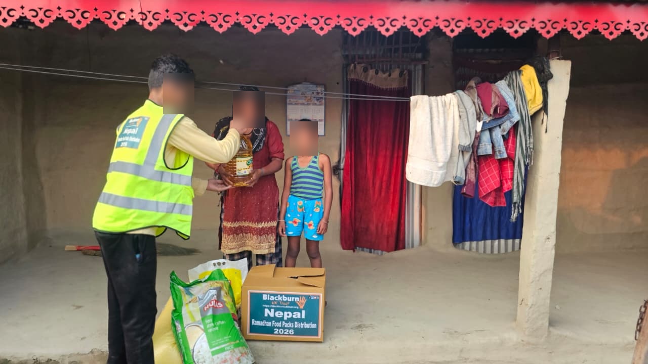 A volunteer delivering essential food supplies to a household
